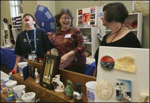 Boutique vendors Kathy Andros, left, Soteria Houlles, and Maria Papps of Sylvania share a laugh at their booth during the 38th annual Greek-American Festival in Toledo. 