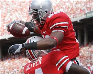 Ohio State wide receiver Ray Small (82) celebrates his touchdown with Nate Oliver (14) during the fourth quarter of an NCAA college football game against Ohio, Saturday, Sept. 6, 2008 in Columbus, Ohio. 