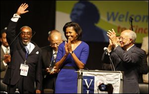 'We can either settle for the world as it is or ... we can fight ... for the world as it should be,' Michelle Obama said.