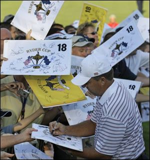 U.S. Ryder Cup team member Kenny Perry, who resides in Franklin, Ky., is inundated with items to be autographed at the  Valhalla Golf Club in Louisville, site of the Ryder Cup tournament.
