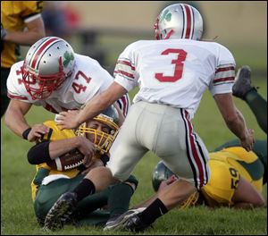 Central Catholic s Jake Henderson tackles Clay s Drew Kuns last night as the Irish s Zach Messner closes in.
<BR>
<img src=http://www.toledoblade.com/graphics/icons/photo.gif> <b>HIGH SCHOOL FOOTBALL WEEK 5:</b> View <a href=http://www.toledoblade.com/apps/pbcs.dll/gallery?Avis=TO&Dato=20080920&Kategori=SPORTS12&Lopenr=920009997&Ref=PH><b><font color=red> Central Catholic - Clay </font color=red> </b></a> football photo gallery
