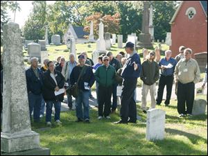 NBRncuster09p 10/4/2008     blade photo by herral long   Dave Ingall gives a tour of cemetary  indicates plot of Capt George Strong  on tour   Custer celebration at Monore's historic Woodland  cemetary - reading and our main grave Was that of col George Custer  there was also a tour by Dave Ingall  of historic sites at he cemetary  see guide