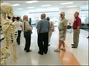 NBRW penta02p   09/28/2008 The Blade/Dave Zapotosky Caption: Gretchen Reichow an instructor in the Exercise Science/Sports Health Care program at the Penta Career Center in Perrysburg, Ohio, explains the program to visitors during the school's open house Sunday, September 28, 2008.  Summary: Open house at the Penta Career Center.