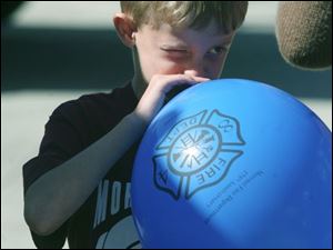 NBRN morenci09p Lisa Dutton/ The Toledo Blade   Morenci, MI 10/04/2008 Eight year old Wyatt Crowell of Morenci,MI  blows up his balloon as large as he can during the open house.  Morenci Fire Department  held an open house in honor their 175 years of service to the community.