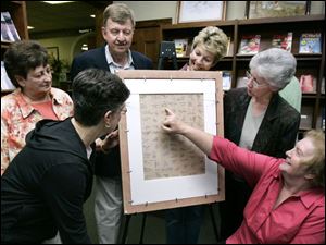NBRW puzzle09p    00/01/2008     Blade Photo/Lori King  from left: Sharon Kolb, Helen Smith, David Dishop, RoseAnn Rittenhouse, Sandy Matheny and Gloria Forrest;  1957 Wauseon graduates who signed the back of this 80-piece Ottawa Indian Chief Wauseon puzzle, which is being  presented to the Wauseon Library in Wauseon, OH.