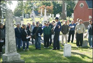 NBRncuster09p 10/4/2008     blade photo by herral long   Dave Ingall gives a tour of cemetary  indicates plot of Capt George Strong  on tour   Custer celebration at Monore's historic Woodland  cemetary - reading and our main grave Was that of col George Custer  there was also a tour by Dave Ingall  of historic sites at he cemetary  see guide