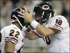 Bears Matt Forte, left, and Kyle Orton celebrate against the Lions on Sunday, when Orton threw for 334 yards and two touchdowns.