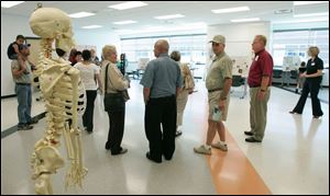 NBRW penta02p   09/28/2008 The Blade/Dave Zapotosky Caption: Gretchen Reichow an instructor in the Exercise Science/Sports Health Care program at the Penta Career Center in Perrysburg, Ohio, explains the program to visitors during the school's open house Sunday, September 28, 2008.  Summary: Open house at the Penta Career Center.