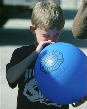 NBRN morenci09p Lisa Dutton/ The Toledo Blade   Morenci, MI 10/04/2008 Eight year old Wyatt Crowell of Morenci,MI  blows up his balloon as large as he can during the open house.  Morenci Fire Department  held an open house in honor their 175 years of service to the community.