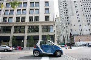 Wayne Anthony stops his Smart Car on Superior Street downtown. The car measures 104 inches long. 
