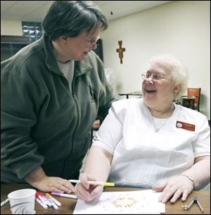 Sister Sharon Havelak, left, and Sister La Donna Pinkelman talk
during a mandala workshop Sister Sharon conducts.