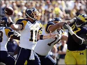 Rockets quarterback Aaron Opelt focuses on a receiver during third-quarter action at Michigan Saturday.
<BR>
<img src=http://www.toledoblade.com/graphics/icons/photo.gif> <font color=red><b>VIEW</font color=red></b>: <a href=