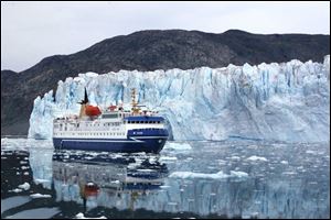 A cruise ship passes by the foot of Greenland s Eqi Glacier, one of the world s most active for calving icebergs. Greenland and its ice sheets are immense. The island spans 1,660 miles from north to south.
<br>
