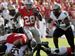 OSU-boots-Purdue-2.jpg Chris 'Beanie' Wells blasts through a hole for some of his 94 yards. He was Ohio State's leading rusher yesterday.