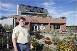 Ralph Semrock's home in Ottawa County, about 10 miles east of Oregon, has extensive insulation, energy-efficient appliances, and solar panels and a wind turbine to generate power.