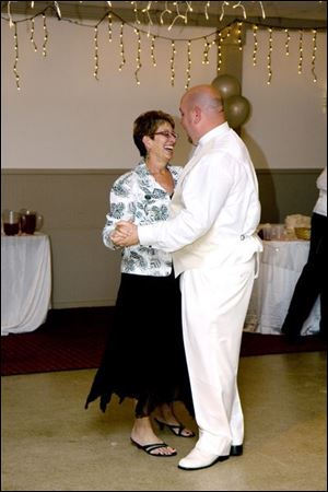 Barb Bunnell, who got a kidney from then-stranger Matt Jones, dances with him at his wedding in June. 