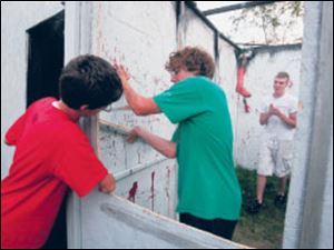 Nick Francis, left, helps Dylan Hanf and Cody Rutkowski work on Hell s Gate.