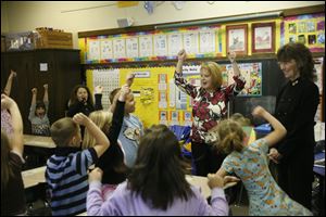 Stacia Timmons Higgins leads a class through the 'phonics dance' at Bowling Green's Ridge school. As the only Ohio teacher to receive the National Educator Award, Mrs. Higgins probably felt like dancing too.