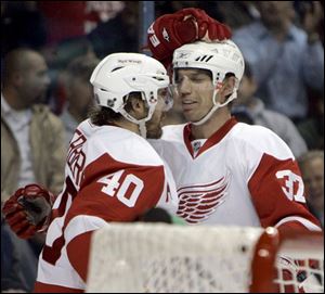 Henrik Zetterberg, left, and Mikael Samuelsson celebrate Zetterberg's first-period goal last night in St. Louis as the Red Wings beat the Blues and improved to 4-1-1 overall.