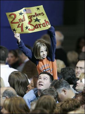 A youngster shows support for Sarah Palin during the
Republican vice presidential nominee s campaign stop at the University of Findlay. Mrs. Palin talked about the tax
plans of the Democrats during her visit to the area.
