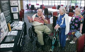Bob Heft, designer of the 50-star flag, talks to senior citizens at Swan Creek Retirement Center.