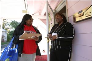 Obama campaign volunteer Charsena Braswell, left, talks with Lisa Jelks outside Ms. Jelks  Old West End home.