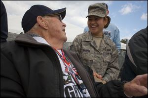 Russ Rhodes, 91, of Holland and Air Force Staff Sgt. Geraldine Harris share a moment during the veteran's trip to Washington.