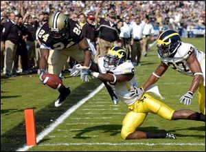 Purdue's Kory Sheets goes airborne to score in the second quarter against the Wolverines. Michigan fell to 2-7.