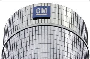 ** FILE ** In this July 25, 2008 file photo, General Motors Corp. headquarters are shown in Detroit. General Motors Corp. on Friday, Nov. 7, 2008 said it lost $2.5 billion in the third quarter and warned that it could run out of cash in 2009. GM also said it has suspended talks to acquire Chrysler, and said its cash burn for the quarter accelerated to $6.9 billion due to a severe U.S. auto sales slump. (AP Photo/Paul Sancya, file)