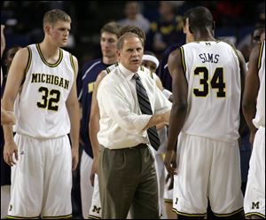 Michigan coach John Beilein, center, instructs his players against Saginaw Valley State last week. Beilein hopes to improve upon UM's 31.2 percentage from 3-point range last season.