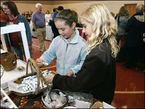 Slug: ROV harvestbazaar           Date: 11/8/2008             The Blade/Amy E. Voigt       Location: Toledo, Ohio  CAPTION:  Josie Iorio (cq), left, and Lauren Shawmaker, right, both from Ottawa Hils, look at lip balms that smell like fruits during the Epworth United Methodist Church's annual Harvest Bazaar on November 8, 2208. The event featured about 50 local and regional vendors selling handcrafted items, jewelry, candles and holiday goodies. All of the proceeds benefit charitable charities.