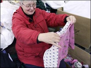 NBRW sale13p  11/08/2008     Blade Photo/Lori King  Toledoan Mary Kwiatkowski sort through clothes for her grandchildren to support the rummage sale to benefit student exchange program at Ottawa Hills High School.