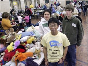 NBRW sale13p  11/08/2008     Blade Photo/Lori King  Exchange students Jasmina Laakso, from Finland, Chili resident Bowen Chen and Ottawa Hills student Nick Deluga volunteer at rummage sale to benefit student exchange program at Ottawa Hills High School.