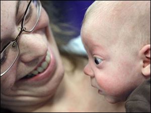 Slug: CTY nicu13p A                                        The Blade/Jeremy Wadsworth  Date: 11/012/08  Caption: Beth Vajen of Napolean, Ohio, holds her son Ethan Saneholtz, 4 months, during a reunion for  patients of the St. Vincent's Children's Hospital Newborn Intensive Care Unit (NICU) that helped mark Prematurity Awareness Day Wednesday, 11/12/08, in Toledo, Ohio. Ethan was born 12 weeks early and weighed one pound 15 ounces.
