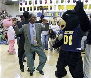 Slug:  NBRW lostboys13p B                                    The Blade/Jeremy Wadsworth  Date: 11/07/08  Caption: The Lost Boys of Sudan Amoil Arop of The Lost Boys of Sudan dances with a mascot during a visit to Whitmer High School Friday, 11/07/08, in Toledo, Ohio. The event kicks off a fundraiser to dig a well in Darfur.