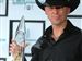 Country Singer Kenny Chesney poses with his Entertainer of the Year award in the press room at the 42nd Annual CMA Awards in Nashville, Tenn., on Wednesday.