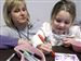 SMALL-WONDERS.jpg Slug: CTY nicu13p C The Blade/Jeremy Wadsworth Date: 11/012/08 Caption: Paula Samples, NICU nurse, helps her daughter Madison, 4, decorate a tile during a reunion for patients of the St. Vincent's Children's Hospital Newborn Intensive Care Unit (NICU) that helped mark Prematurity Awareness Day Wednesday, 11/12/08, in Toledo, Ohio.