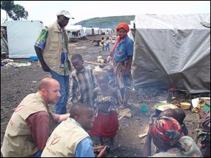 Luke King, left, consults with residents of a displacement camp in the conflict-ridden Democratic Republic of Congo.
