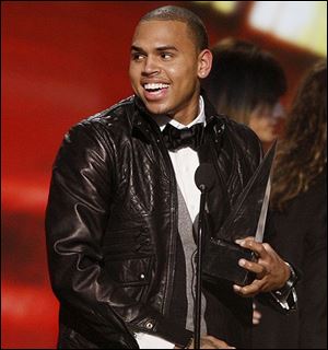 Chris Brown accepts the artist of the year award at the American Music Awards in Los Angeles on Sunday, Nov. 23, 2008.
