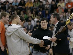 CTY champs03p        12/02/2008     Blade Photo/Lori King  Alex Pidcock, left, watches Greg Isley shake hands with principal Dave McMurray, as Southview High School students are presented with the football state championship trophy during a morning assembly. center in black is T.J. Gibbs.