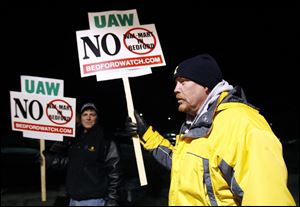 Charlie Cole, front, protests zoning changes in Bedford Township that some fear will pave the way for big-box stores.