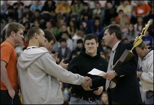 CTY champs03p        12/02/2008     Blade Photo/Lori King  Alex Pidcock, left, watches Greg Isley shake hands with principal Dave McMurray, as Southview High School students are presented with the football state championship trophy during a morning assembly. center in black is T.J. Gibbs.