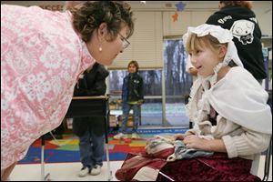 Slug: NBRN wax04p           Date: 11/25/2008             The Blade/Amy E. Voigt       Location:  Temperance, MI  CAPTION:   Kyla Daudelin, right, a 4th-grade student in Sarah Anderson's class, plays Betsy Ross while 5th grade teacher Beth Johnston, left, listens, during a wax museum presentation the class is doing as part of their studies on biographies and  autobiographies at Smith Road Elementary on November 25, 2008.