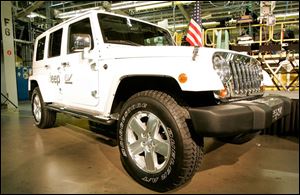 Tom LaSorda said the electric-drive Wrangler, on display during the rally at Toledo Supplier Park, would be built at the Jeep Assembly complex if the $34 billion federal bailout passes.