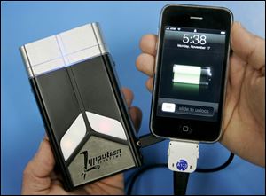 A fuel-cell charging system, left, is about the same size as a mobile phone.