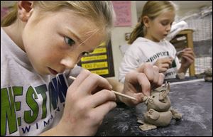 Kyleigh Baird, left, makes a rabbit out of clay while Madison Shimboroske, works on her own project. The creations are inspired by the book City Beats: A Hip-Hoppy Pigeon Poem.