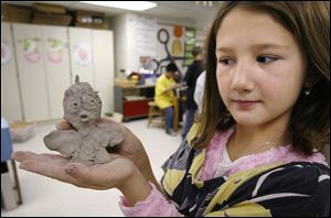 Miranda Hupp, 9, displays the Tweety Bird she crafted from clay in art class. Her work was inspired by the book City Beasts: A Hip-Hoppy Pigeon Poem illustrated by Jeanette Canyon.
