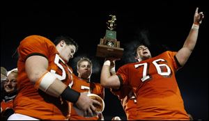 From left, T.J. Gibbs, Alex Pidcock and Jim McMahon celebrate after Southview won the Division II state football title with a win over Cincinnati Anderson.