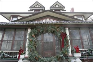 A wreath made from tree boughs encircles the front door of the home of Bill Thien and Gary Sears at 2514 Parkwood Ave. The home will be featured in Tours de Noel, the annual holiday tour of homes in the Old West End of Toledo. 