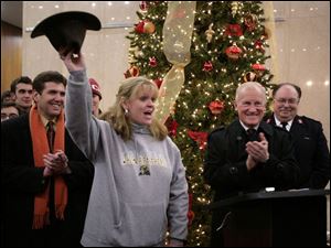 Slug:   CTY tree06p    Date: 12/04/2008        The Blade/Andy Morrison       Location: Toledo     Caption:  Jackie Frisch raises a hat full of money raised during the short press confence she, Mayor Carty Finkbeiner and others held announcing the kick-off of "Kids Saving Christmas, " before the lighting of the city's Christmas tree at One Government Center, Friday, 12/05/2008. The event was moved indoors because of the cold.    Summary:
